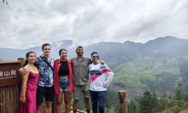 5-Day Hidden Gem - Guizhou Retreat: Caves, Culture, and Culinary Delights, china, china tour, Five friends posing together on a wooden overlook with misty mountains and terraced hills in the background.