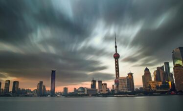 shanghai, china, china tour, Evening cityscape of Shanghai with the Oriental Pearl Tower and modern skyscrapers along the river