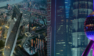 shanghai, china, china tour, Night aerial view of a dense city at night with a river and glowing skyscrapers along the waterway.