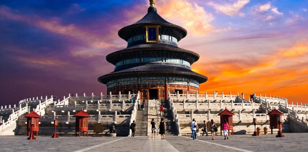 Beijing's Temple of Heaven, china, china tour, Beijing's Temple of Heaven at sunset, a three-tiered circular pavilion on white marble terraces with visitors walking up the steps.