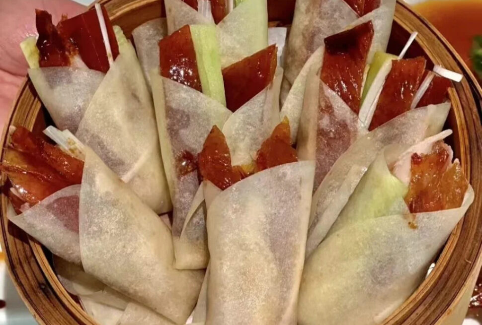 beijing duck, china tour, Basket of translucent spring rolls filled with char siu pork and vegetables, arranged upright in a wooden steamer basket.