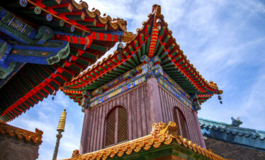 Architectural Details of Pusading, Mount Wutai, shanxi, china, china tour, Colorful Chinese temple roof with ornate eaves and decorative motifs against a blue sky