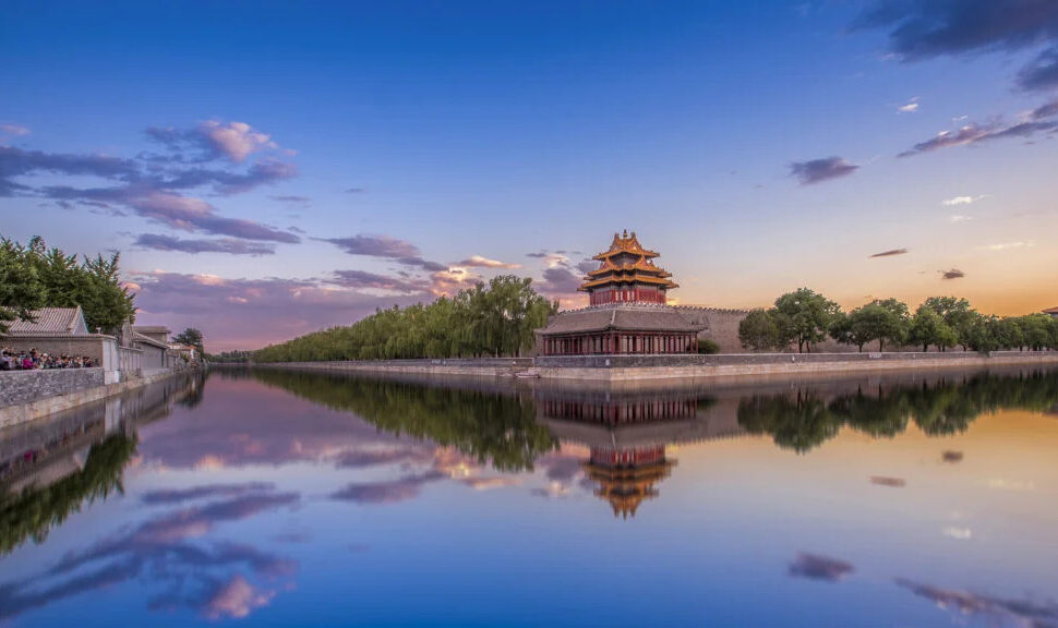 forbidden city, beijing, chinatrave, Traditional Chinese pagoda by a lake at sunset, reflected in the calm water.