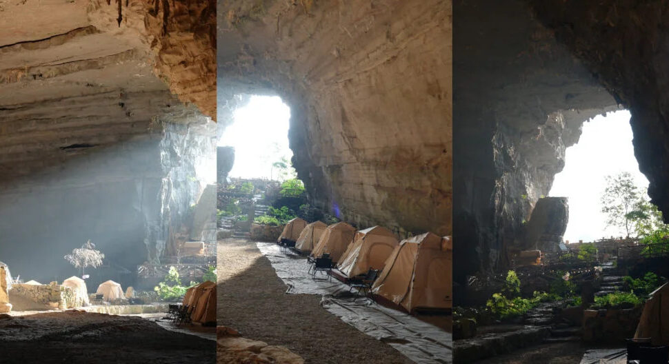 cave camping, guizhou, chinatravel, Campsite inside a large rocky cave with beige tents lined along a sunlit passage.