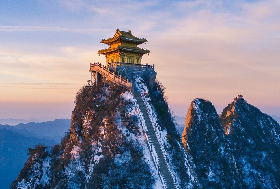 Laojun mountain, luoyang, henan, china tour, Temple atop a snow-covered peak with a long staircase leading to it at sunset/blue hour, mountains in the distance