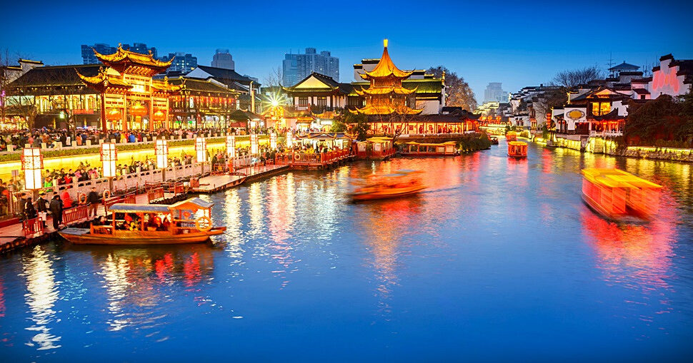 Fu Zi Temple, nanjing, jiangsu, china tour, Night canal scene in a traditional Chinese town with illuminated pavilions and boats on the water along a lit promenade.