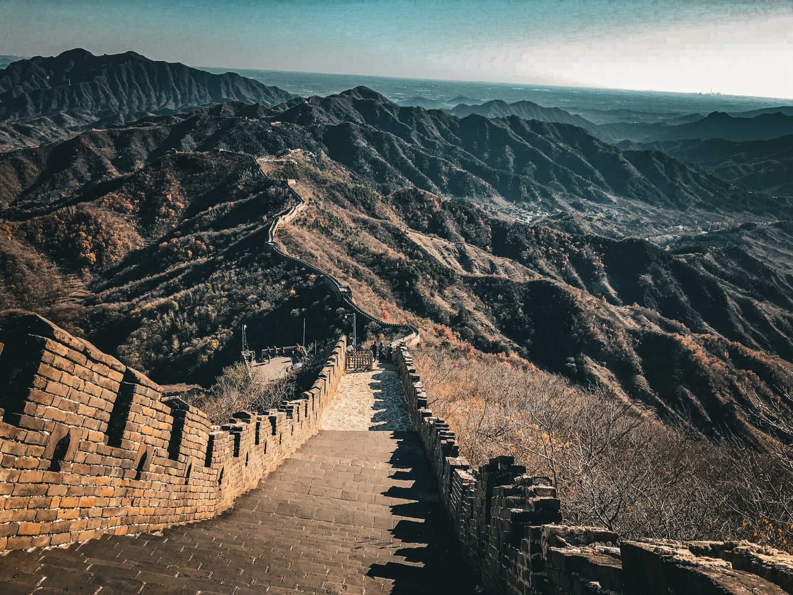 the great wall, beijing, chinatrip, Stone steps and watchtowers of the Great Wall wind over rugged hills toward the horizon.