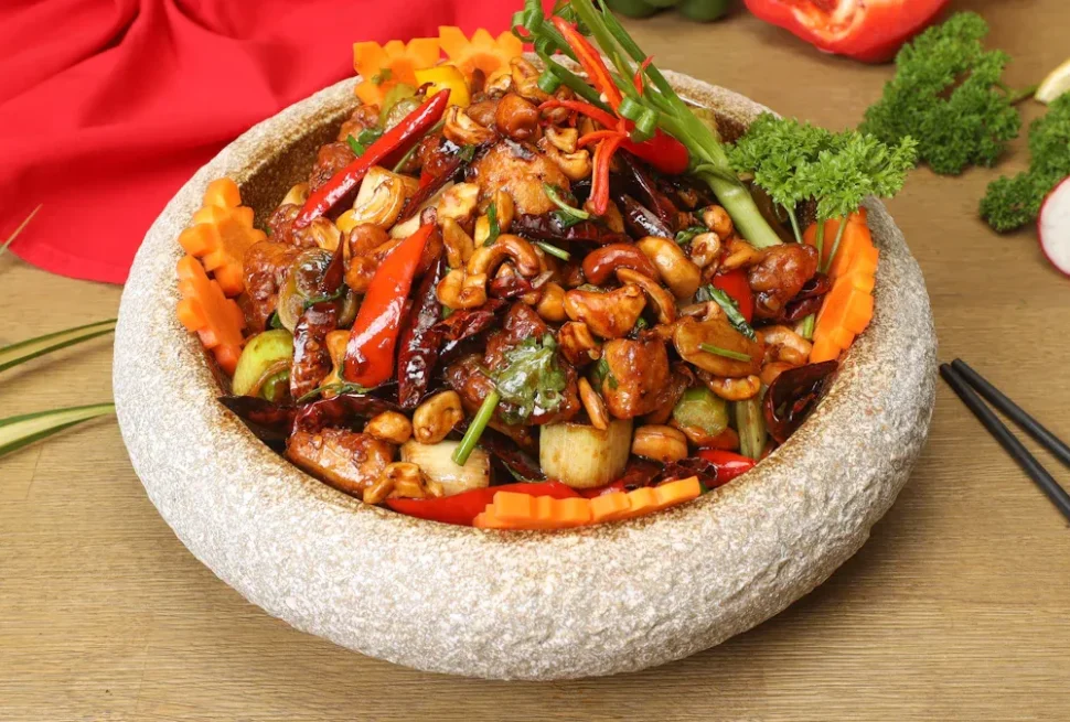 chinese food, chinatrip, Stir-fried vegetable and nut medley (cashews, peppers, carrots) served in a round stone mortar bowl with chopsticks nearby