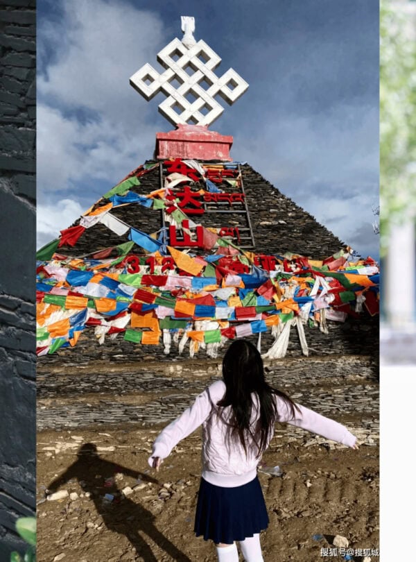 Dongda Mountain Pass,Tibet,Chinatour Girl in a white jacket and navy skirt stands with arms outstretched before a multi-colored prayer-flag covered stupa under a blue sky.