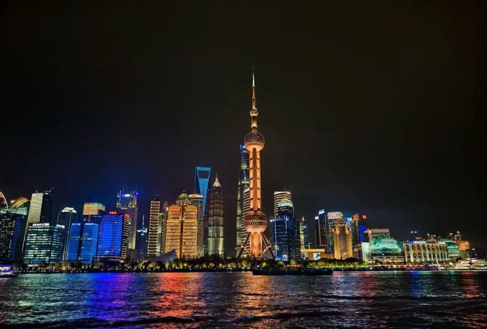 Pearl Tower,Shanghai,Chinatour Night view of Shanghai skyline along the Huangpu River, with the Oriental Pearl Tower lit up on the horizon.