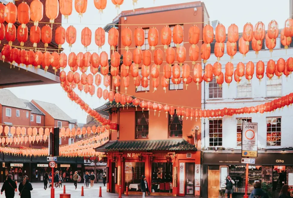 Niujie Mosque,Beijing,Chinatour Pedestrian street lined with hanging red lanterns overhead, with shop fronts and people walking during a festival.