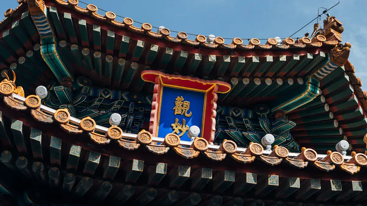 Close-up of an ornate Chinese temple roof with green beams, gold tiles, and a blue plaque bearing gold Chinese characters.