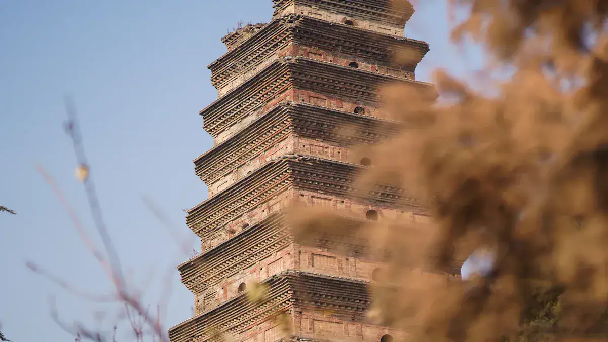Wild Goose Pagoda,Shanghai,Chinatour Brick, multi-tiered pagoda rising against a blue sky, with blurred foreground branches partially obscuring it.