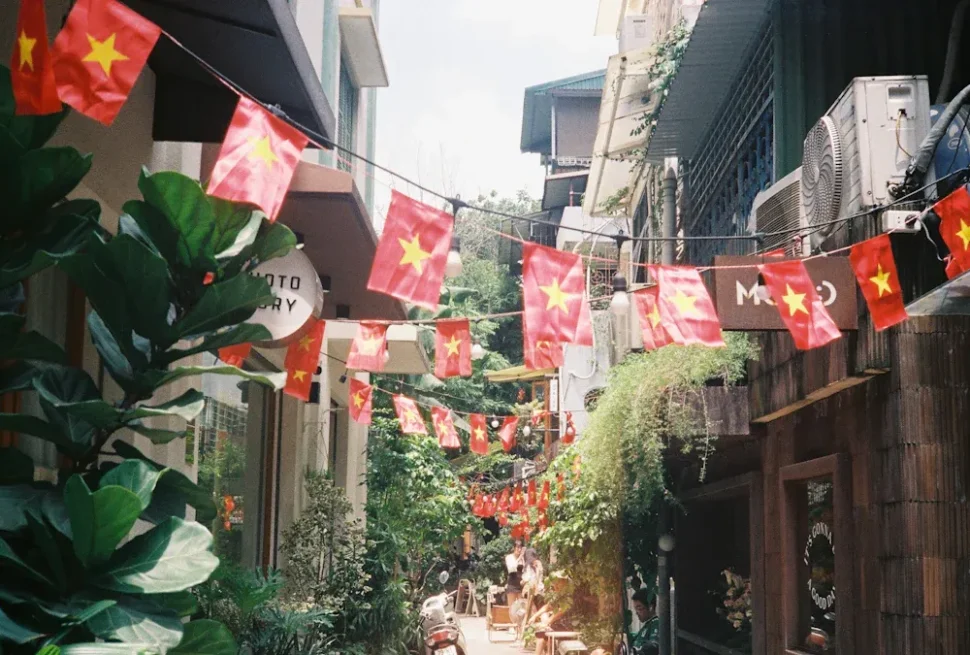 Tianzifang,Shanghai,Chinatour Narrow street decorated with Vietnamese flags strung overhead between buildings.