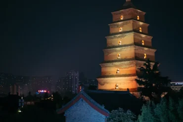 The Big Wild Goose Pagoda,Xi`an,Chinatour Seven-story illuminated pagoda at night with city skyline in the background, warm lights glowing from the windows