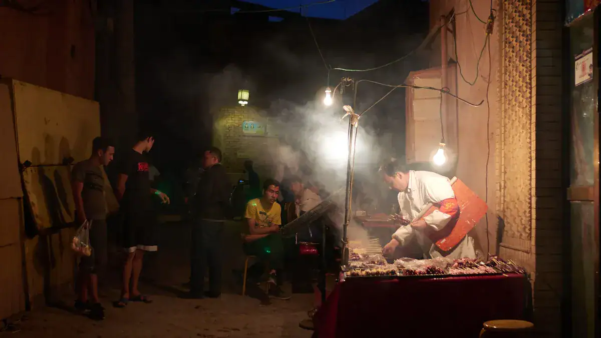 Kuanzhai Alleys,Chengdu,Chinatour Night street food stall with a cook grilling skewers under hanging bulbs as customers wait nearby in a smoky, dimly lit alley.