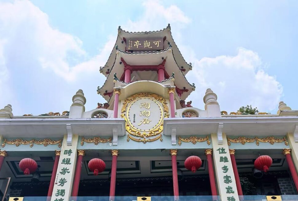 Shangxiajiu Pedestrian Street,Guangzhou,Chinatour Front view of a Chinese temple with red columns, gold ornamentation, and red lanterns against a blue sky.