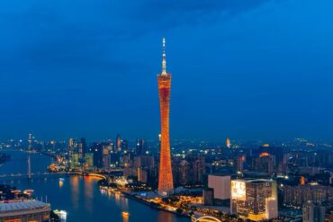 Canton Tower,Guangzhou,Chinatour Guangzhou skyline at dusk with the illuminated Canton Tower along the Pearl River and surrounding buildings reflect in the water