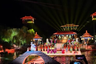 Song of Everlasting Sorrow,Xi`an,Chinatour Night-time outdoor stage with a colorful traditional Chinese performance on a lit, multi-tiered platform over water