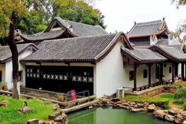 Traditional Chinese courtyard house with curved tile roofs beside a small pond and rock garden.Yuelu Academy,Changsha,Hunan ,Chinatravel