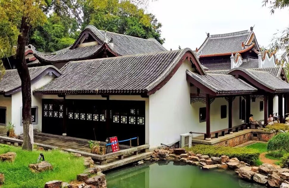 Traditional Chinese courtyard house with curved tile roofs beside a small pond and rock garden.Yuelu Academy,Changsha,Hunan ,Chinatravel