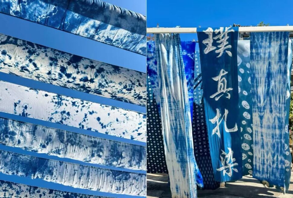 Blue tie-dyed fabric strips hang vertically, forming an outdoor textile display.Zhoucheng Village,Dali,Yunnan,Chinatravel