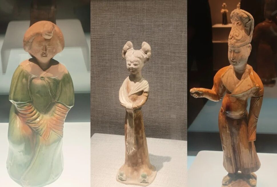 Henan Museum,Luoyang,Chinatour Triptych of ceramic figurines on display: a left green-gowned figure, a middle slim figure with two buns, and a right orange-robed figure with a raised arm.