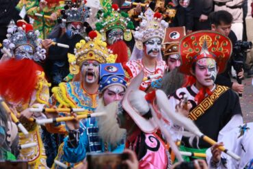 Group of performers in ornate Chinese opera costumes and masks, holding yellow and white sticks at a festival.𝐂𝐡𝐚𝐨𝐬𝐡𝐚𝐧 𝐂𝐡𝐢𝐧𝐞𝐬𝐞 𝐍𝐞𝐰 𝐘𝐞𝐚𝐫,Guangdong,Chinatravel