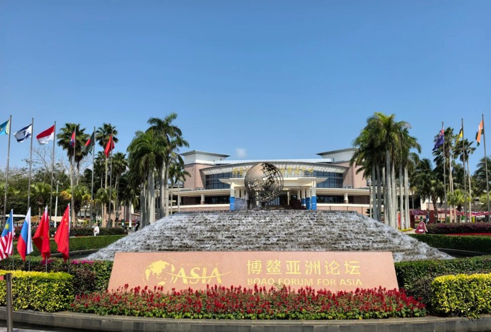 Bo’ao Forum for Asia Conference Center,Qionghai,Hainan,Chinaexplorertour Boao Forum for Asia sign in front of a tiered fountain and globe sculpture, with flags and palm trees.