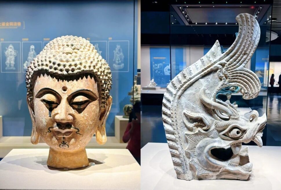 Ningxia Museum,Yinchuan,Ningxia,Chinatravel Two museum sculptures: left a tranquil Buddha head with textured hair; right an ornate dragon head carving with an open mouth and detailed patterns.