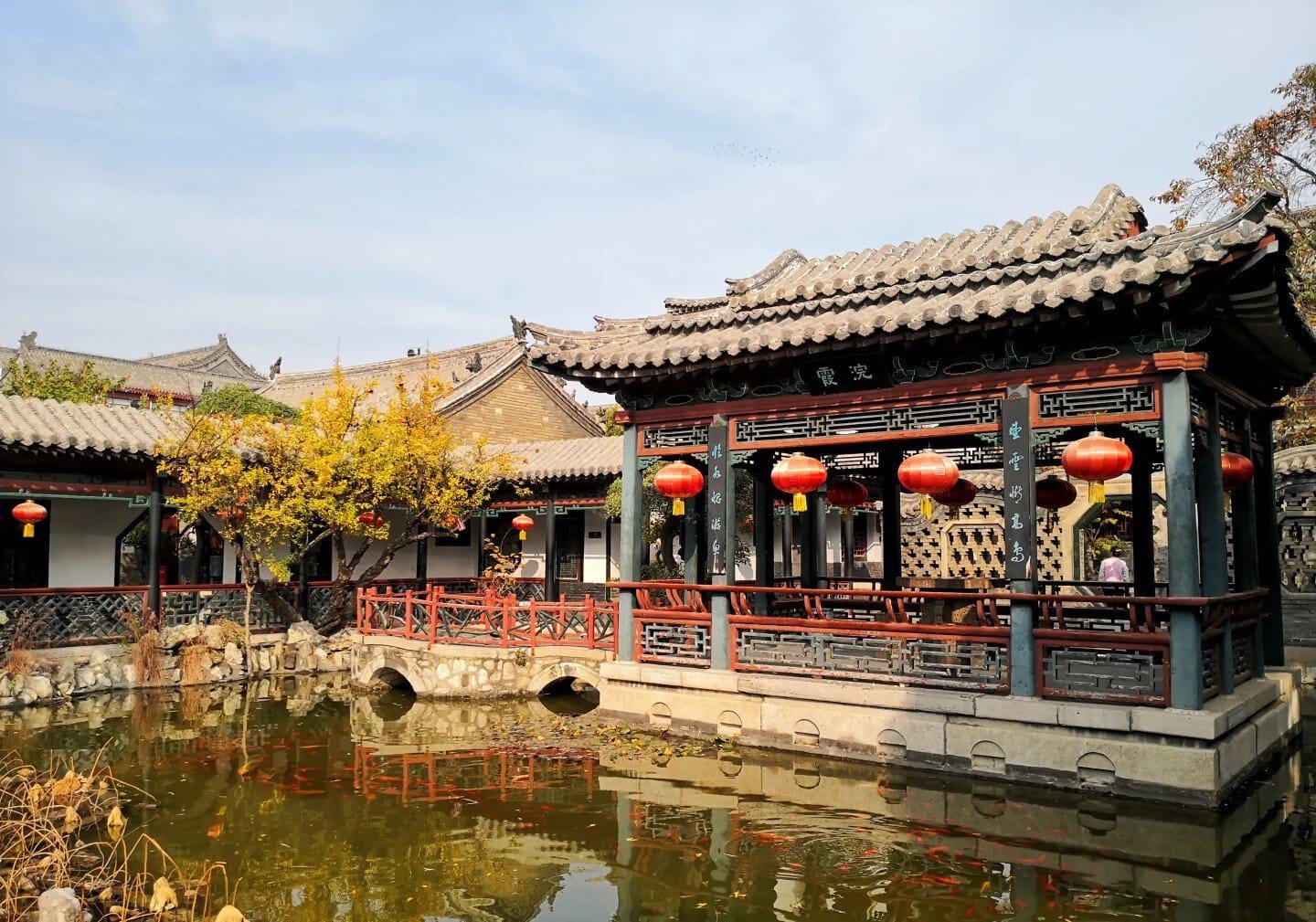 Traditional Chinese pavilion with red lanterns over a pond in a historic garden,Shihu Garden, weifang, shandong, chinatrip