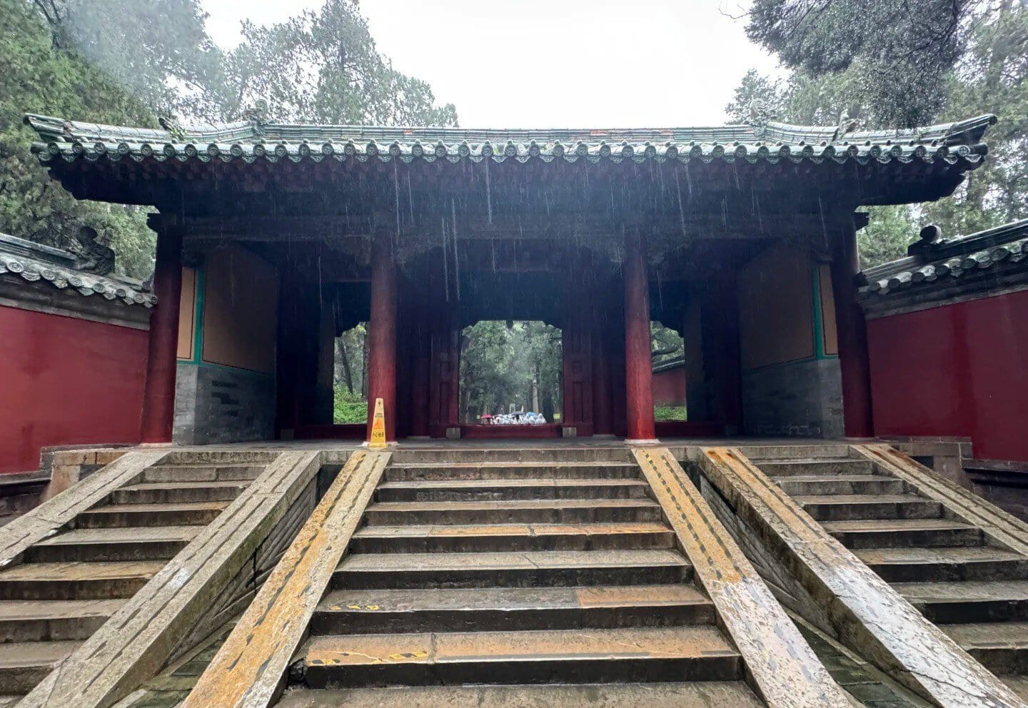Ancient Chinese temple gate with stone steps and traditional architecture.