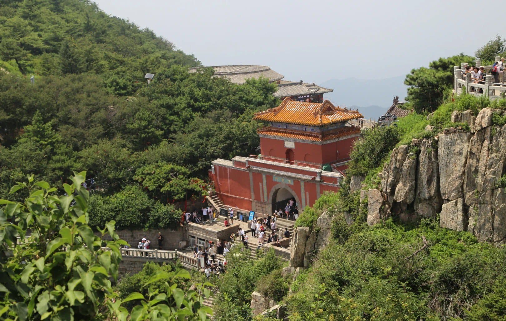 South Gate to Heaven,Tai`an,Chinatour Ancient Chinese temple on Mount Hua surrounded by lush greenery and rocky cliffs.