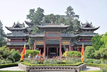 Traditional Chinese temple complex with ornate tiled roofs and red wooden arches, set in a landscaped garden.Xièzhou Guandi Temple,Yuncheng,Shanxi