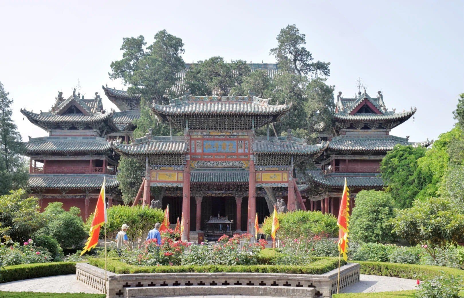 Traditional Chinese temple complex with ornate tiled roofs and red wooden arches, set in a landscaped garden.Xièzhou Guandi Temple,Yuncheng,Shanxi