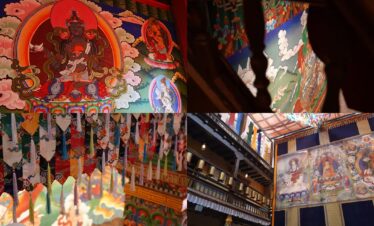 A vibrant interior view of a Tibetan Buddhist monastery with colorful murals and decorations.