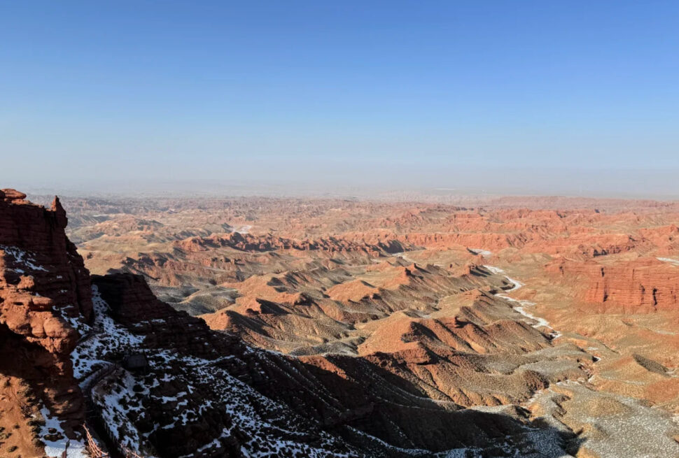 Pingshan Lake Grand Canyon,Zhangye,Chinatrip Grand Canyon with snow on the ridges, showing layered rock formations and a clear blue sky.