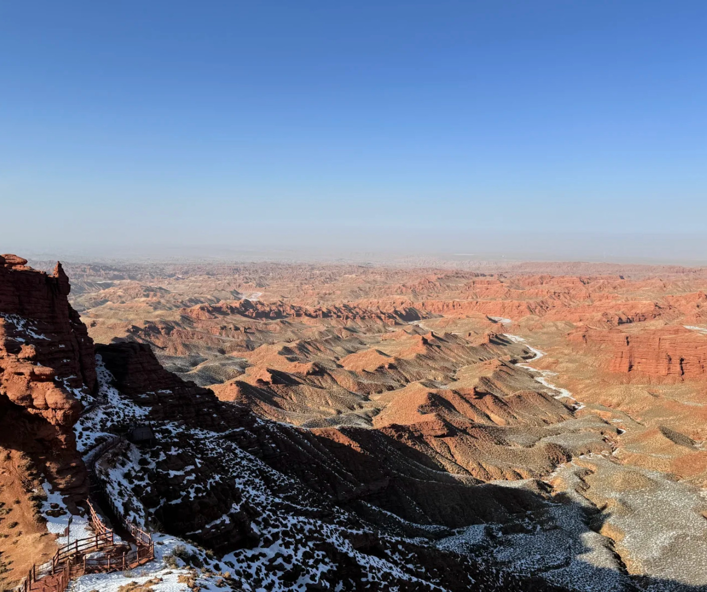 Pingshan Lake Grand Canyon,Zhangye,Chinatrip Grand Canyon with snow on the ridges, showing layered rock formations and a clear blue sky.