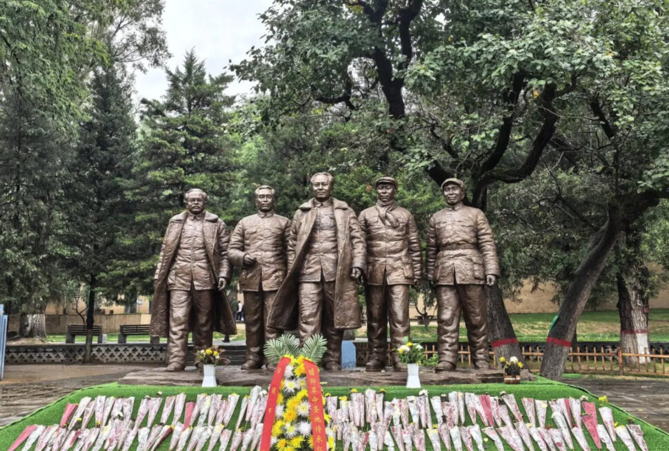 Zaoyuan Revolutionary Former Site ,Yan`an,Chinatrip Bronze statues of five soldiers standing in a park with trees and flowers in front.