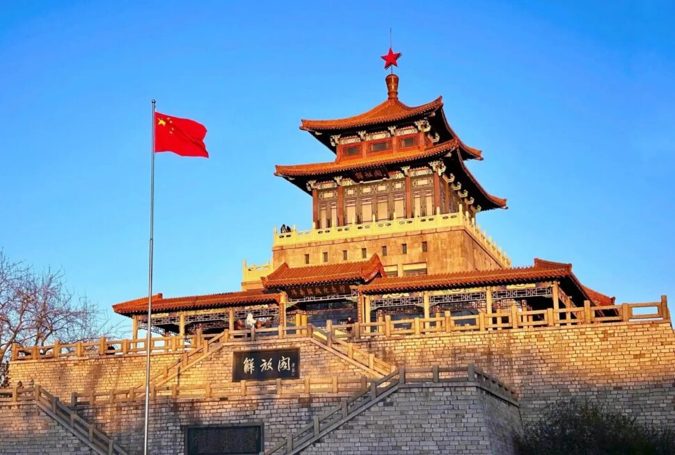 Liberation Pavilionin,Jinan,Chinatour Traditional Chinese pavilion with a red flag on a pole, under a clear blue sky.