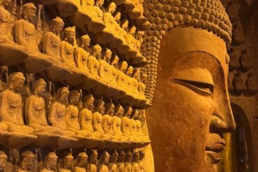 Thousand Buddha Temple,Jinan,Chinatour Large Buddha head and numerous small Buddha statues at Longmen Grottoes, China.