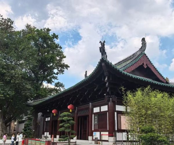 Guangxiao Temple,Guangzhou,Chinatour Traditional Chinese temple with a green-tiled, curved roof and red lanterns hanging along the entrance.