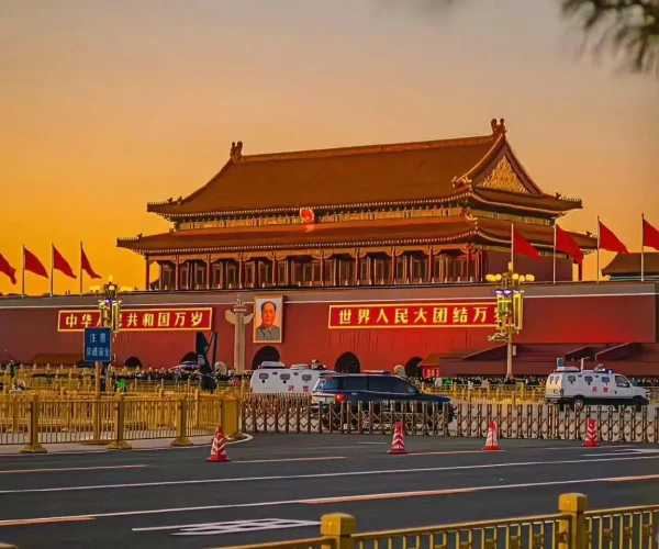 Tiananmen Gate, beijing, chinatravel, Sunset view of Tiananmen Gate with red banners, Mao portrait, and ceremonial lamps, cars and barriers in the foreground