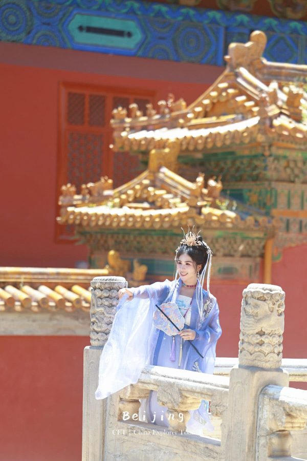 Hanfu photoshoot, Beijing, Imperial Ancestral Temple (Tai Miao), female, chinatravel, Woman in a blue traditional Hanfu with an elaborate headdress posing on a stone railing at a Beijing temple, ornate gold roof in the background