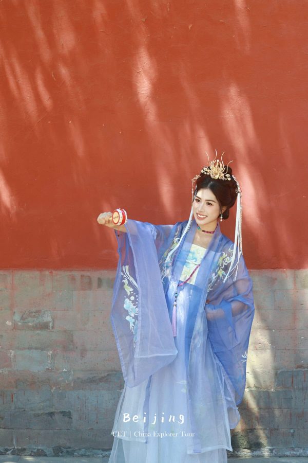 Hanfu photoshoot, Beijing, Imperial Ancestral Temple (Tai Miao), female, chinatravel, Woman in a blue traditional Chinese dress with an ornate crown, posing with a red-and-white circle prop against a red wall; text 'Beijing' at bottom.