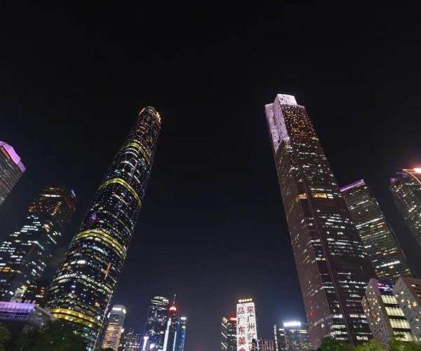Zhujiang New Town CBD,Guangzhou,Chinatour Nighttime city skyline with tall, illuminated skyscrapers against a dark sky, colorful building lights creating a vibrant urban vista