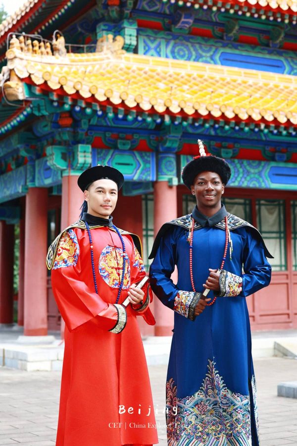 Hanfu Photoshoot, Beijing, Zhongshan park, male, friends, chinatravel, Two men in bright red and royal blue traditional Chinese imperial robes pose outdoors in front of a colorful ornate temple roof.