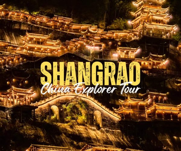Shangrao,Jiangxi Nighttime view of a hillside covered with glowing traditional Chinese buildings, with bold yellow text 'SHANGRAD' and white script 'China Explorer Tour' overlaying the scene