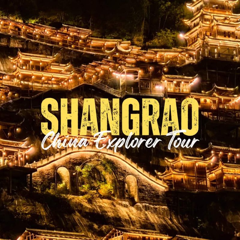 Shangrao,Jiangxi Nighttime view of a hillside covered with glowing traditional Chinese buildings, with bold yellow text 'SHANGRAD' and white script 'China Explorer Tour' overlaying the scene