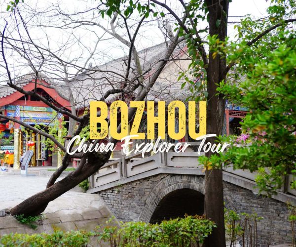 Bozhou,Anhiu,China tour Promotional image for Buzhou China Explorer Tour showing a stone arched bridge and temple with overlaid yellow text.